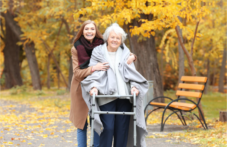 senior woman with caregiver outside