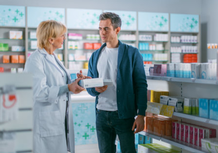 pharmacist  showing medicine to client